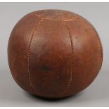 A vintage leather medicine ball.