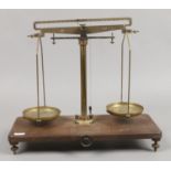 A set of brass Griffin & George apothecary scales on bakelite stand.