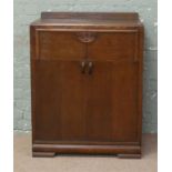 A 1940s carved oak tallboy.