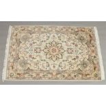 An Oriental cream ground wool rug with a central medallion design, 1m 4cm x 1m 57cm. Condition