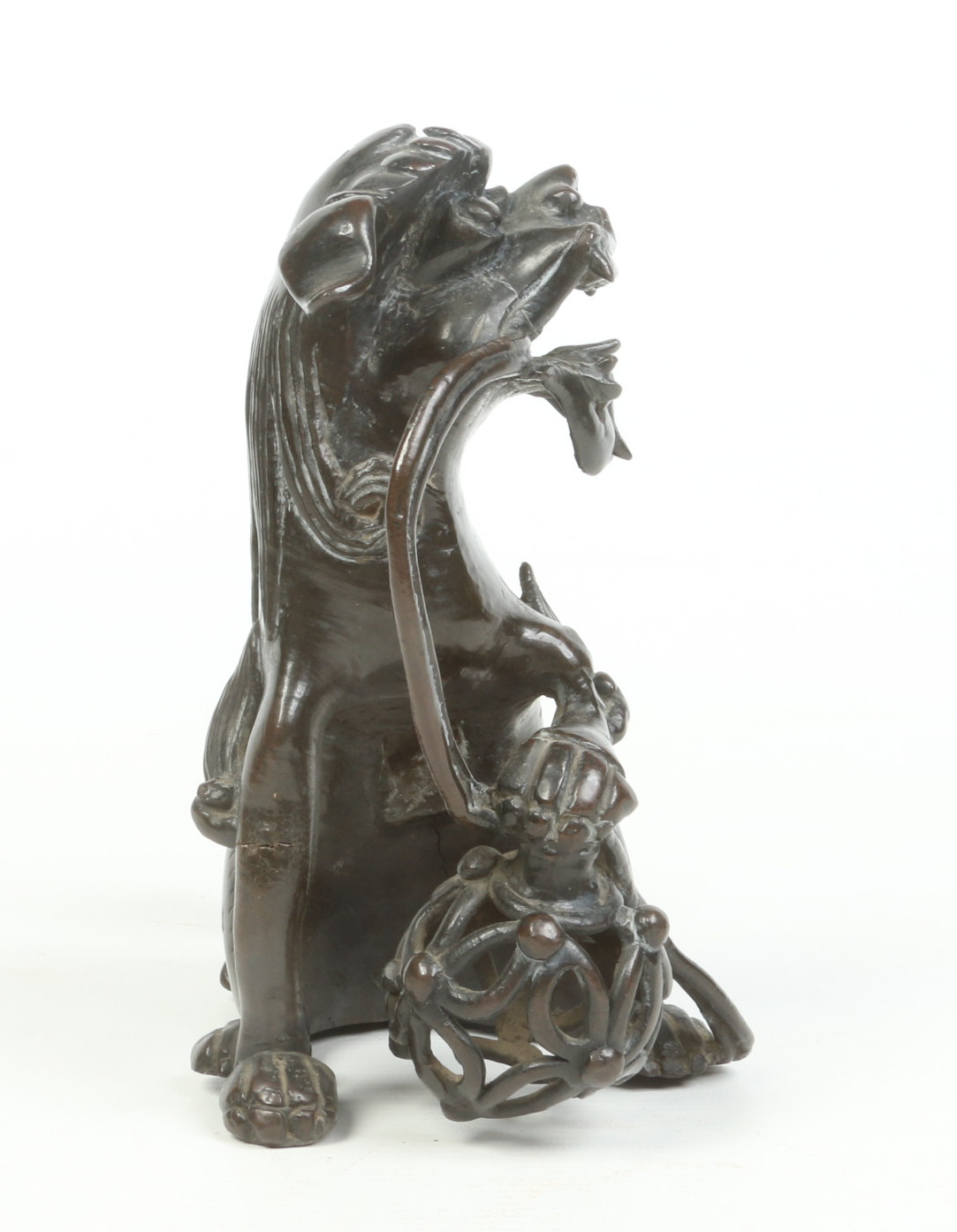 An antique Chinese patinated bronze sculpture of a lion dog guarding a brocade bowl, possibly - Image 6 of 7