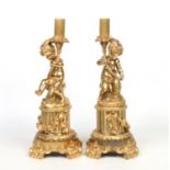 A pair of 19th century French large gilt bronze lamp bases. Each formed as a putti supporting an