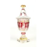 A Bohemian glass pedestal vase and cover. Ruby flash and etched with panels depicting figures and