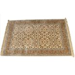 An ivory ground silk rug with a Tabriz style design, 155cm x 235cm.