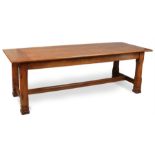 A Victorian Gothic revival oak plank top refectory table in the manner of A. W. N. Pugin. Raised