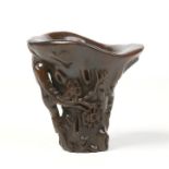 A 19th century Chinese horn libation cup. Carved in high relief with prunus blossom. Four