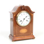 An early 20th century mahogany cased eight day mantel clock. With carved swan neck pediment,