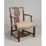 An antique Chippendale style carved mahogany open armchair. With pierced baluster shaped centre