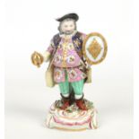 A 19th century Derby figure modelled as Falstaff. Decorated in coloured enamels and raised on a