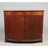 An Edwardian mahogany bow front sideboard with strung inlay, having a three drawer frieze and