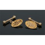 A pair of Chinese 18 carat gold cufflinks. Each with an ovoid panel inscribed with an applied