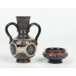 A Doulton Lambeth twin handled stoneware vase with tapering neck. Decorated with beadwork and