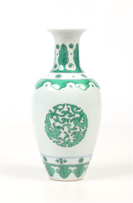 A small Chinese baluster shaped vase. Outlined in underglaze blue and painted in green enamel with