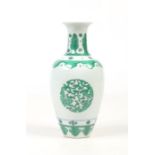 A small Chinese baluster shaped vase. Outlined in underglaze blue and painted in green enamel with