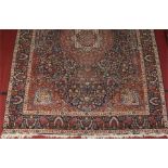 A 19th century hand woven Persian blue ground wool carpet. With a large centre medallion under a