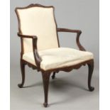 A 19th century Georgian style mahogany Gainsborough armchair. With undulating cresting rail,