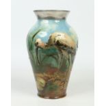 A Burmantofts art pottery impasto baluster shaped vase. Decorated with a heron in a continuing