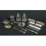 A George V silver mounted thirteen part dressing table set by Finnigans Ltd. Engraved with scrolls