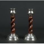 A pair of silver mounted carved oak barleytwist candlesticks. Assayed Birmingham 1928, 17cm.