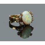 An 18 carat gold, diamond and opal ring of abstract form. Set with six diamonds flanking the large