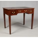 An early 19th century mahogany leather top writing table. With three drawers and raised on square