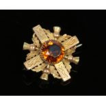 A 15 carat gold Scottish brooch. Set with a round cut citrine and formed as a Celtic cross