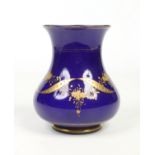 An opaque Bristol blue glass vase of baluster form, engraved and gilded with ribbon and flower