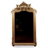 A large Victorian giltwood and gesso pier mirror. The arched top adorned with a pair of putti