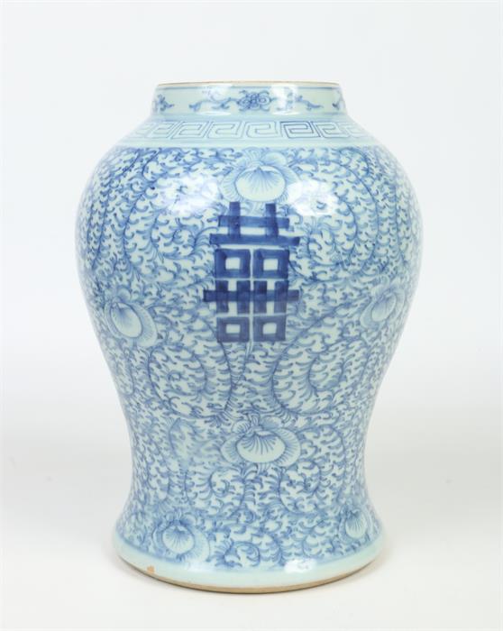 A large 19th century Chinese baluster vase. Painted in underglaze blue with a key fret collar, lotus