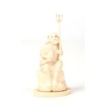 A Japanese Meiji period carved ivory okimono. Formed as a fisherman seated upon a rock, holding a