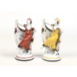 Two Continental Art Deco porcelain figures of dancing girls decorated in coloured enamels. Impressed