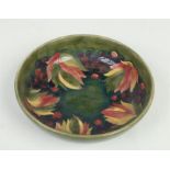 A large Moorcroft green ground bowl decorated in the leaves and berries design. Impressed marks,