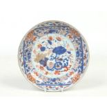 A 19th century Chinese Imari dish. With a wide stylized floral border and painted to the centre with