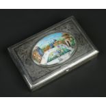 A Persian silver rectangular cigarette box. Engraved with scroll work and with and oval enamel