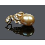 An 18 carat gold diamond and pearl pendant of berry form. With a large baroque pearl of gold hue