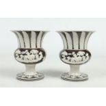 A pair of early 19th century sprigged stoneware pedestal vases of tapering form, probably