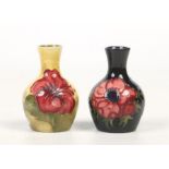 Two small Moorcroft bottle vases. One ground in cobalt blue and decorated with the Anemone