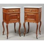 A pair of early 20th century French oak and marble top pot cupboards. With ormolu handles and raised