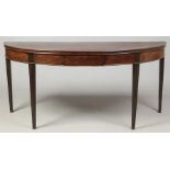 A 19th century bow front serving table. With concealed drawer to the frieze and raised on reeded