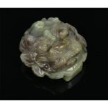 A well carved Chinese mottled spinach jade buckle in form of a lion mask, 5cm wide.  Condition