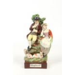 A 19th century pearlware figure group modelled as a shepherd and his companion and coloured in