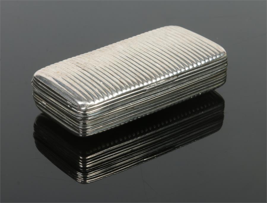 A Georgian silver snuff box with reeded moulding and gilt interior. 49 grams, 6.5cm. Condition