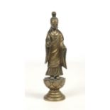 An early 19th century Chinese bronze small statue. Modelled as Guanyin stood upon a lotus plinth and