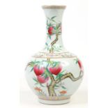 A Chinese Guangxu (1875-1908) large bottle vase. Painted in coloured enamels with a fruiting peach