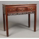 A Chinese late Qing dynasty hardwood three drawer alter table with dreamstone inset marble top.