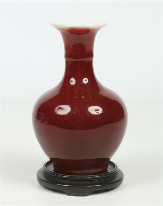 A Chinese small baluster vase on hardwood plinth. With ring moulded neck and decorated in sang de - Image 6 of 6