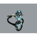 An 18 carat white gold dress ring claw set with an ovoid aquamarine. Stone 12mm x 8mm, ring size