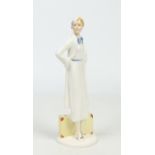 A Continental Art Deco Lenci style pottery figure of a lady stood with a suitcase by her side, 32cm.