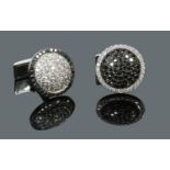 A pair of gentleman's 18 carat white gold cufflinks pave set with black and white diamonds, disc