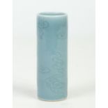 A small Chinese cylindrical brush pot. Decorated in Clare de Lune glaze and moulded in relief with